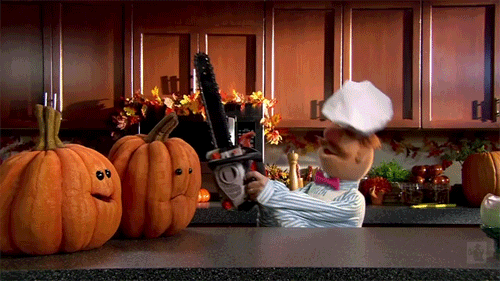 Gif of Chef from the Muppets using a chainsaw to cut pumpkins.
