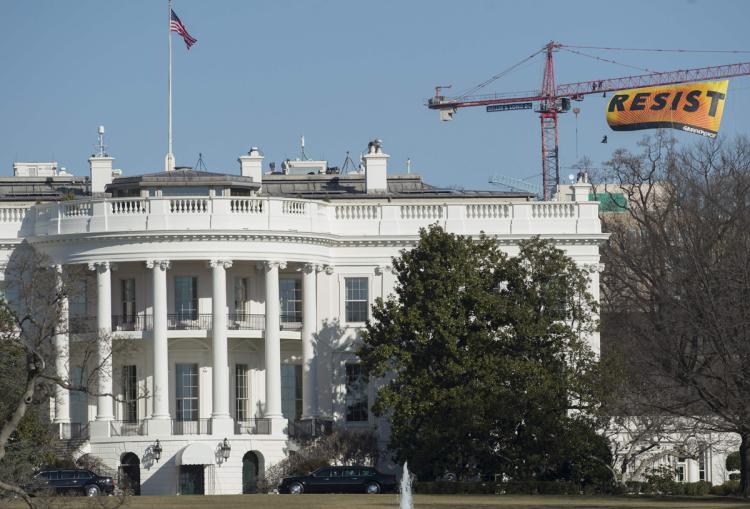 white house with sign that says resist