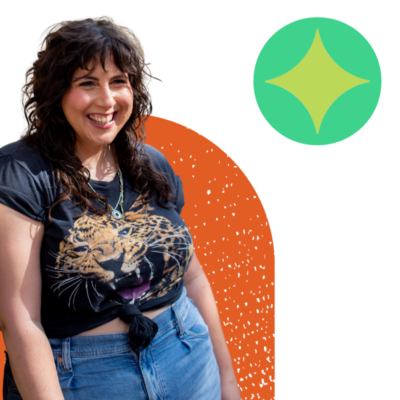 photo of Alisa smiling in a black t shirt with colorful shapes in the background